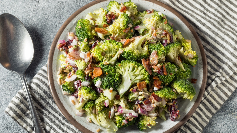 Broccoli salad on a plate with a spoon