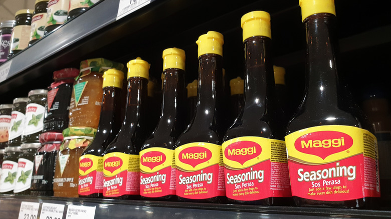 Bottles of Maggi Seasoning on a grocery store shelf