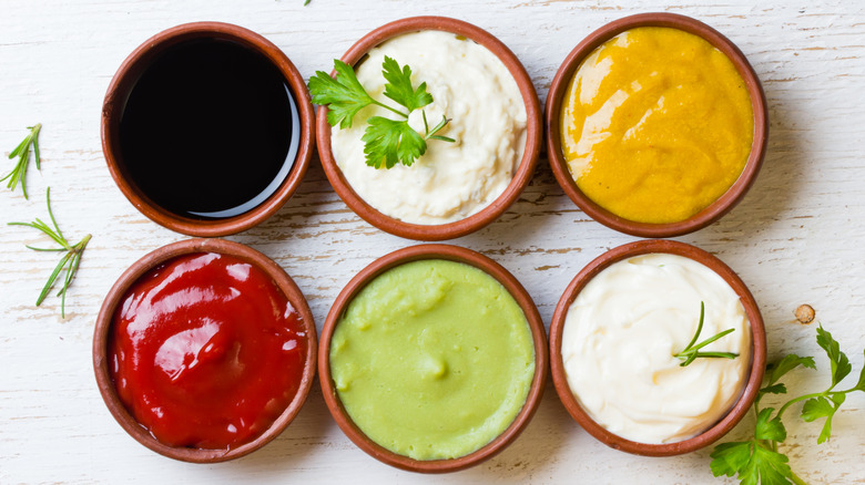 Six small bowls with various condiments