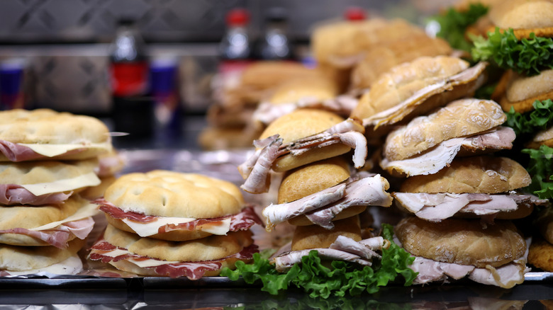Stacks of sandwiches displayed alongside one another in a case