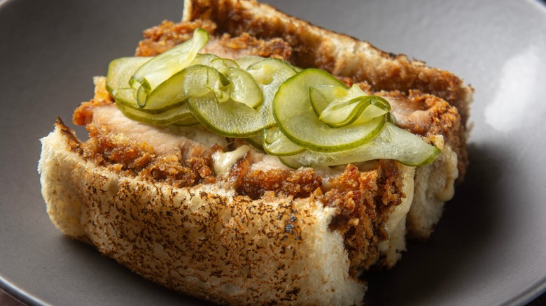 Katsu sand combines pork fillet breaded in panko flour, pickles, and Kewpie mayonnaise