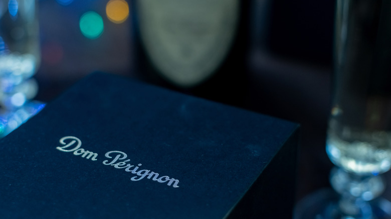 Fancy box of Dom Pérignon with a bottle of the same wine in the background