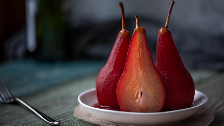 Stewed purple pears arranged on a plate