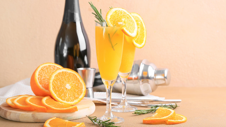 Mimosas with bottle and oranges