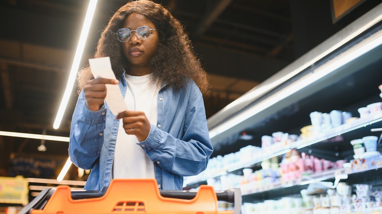 person checking grocery receipt