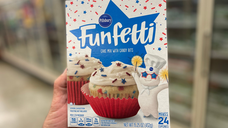 Hand holding Pillsbury Funfetti cake mix