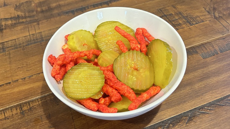 Hot Cheetos and pickles in bowl