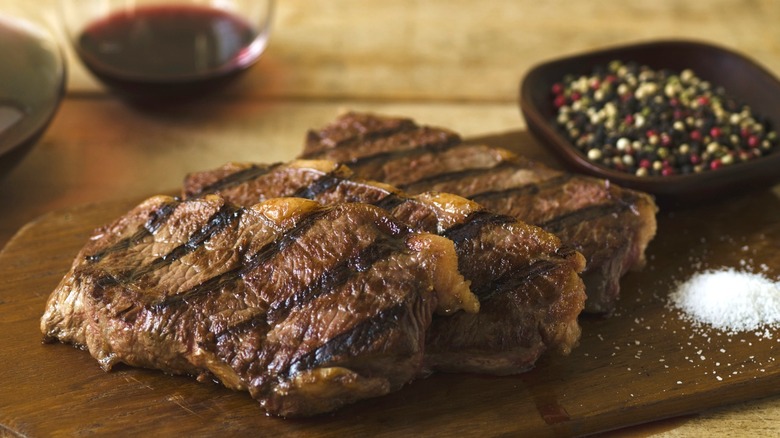 Grilled steaks resting on a cutting board