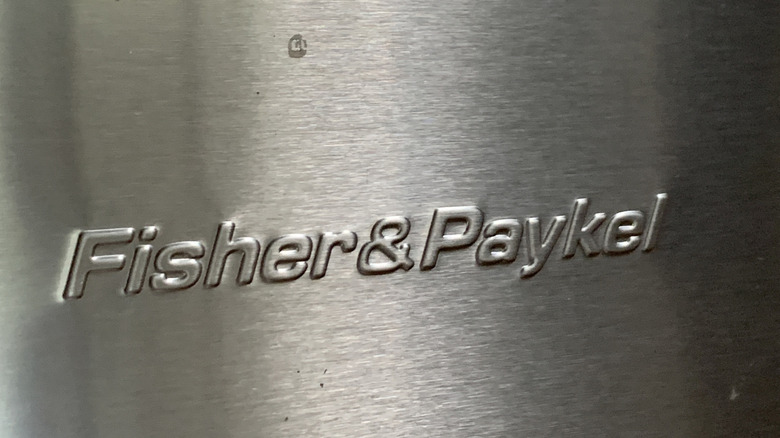 Close up of Fisher and Paykel logo on stainless steel fridge