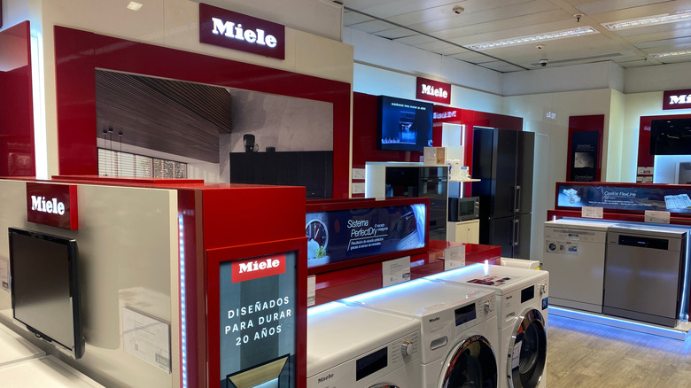 Miele showroom displays modern washing machines and kitchen appliances