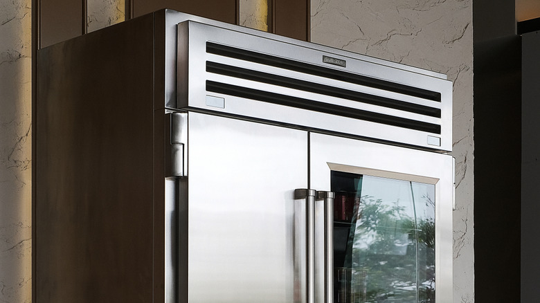 Top half of a stainless steel sub zero brand refrigerator with two doors and window
