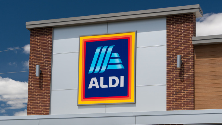 A woman shops in the aisle of an Aldi market