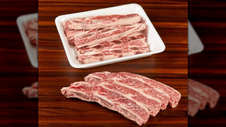 The short ribs from Costco in a Styrofoam tray on a wooden surface