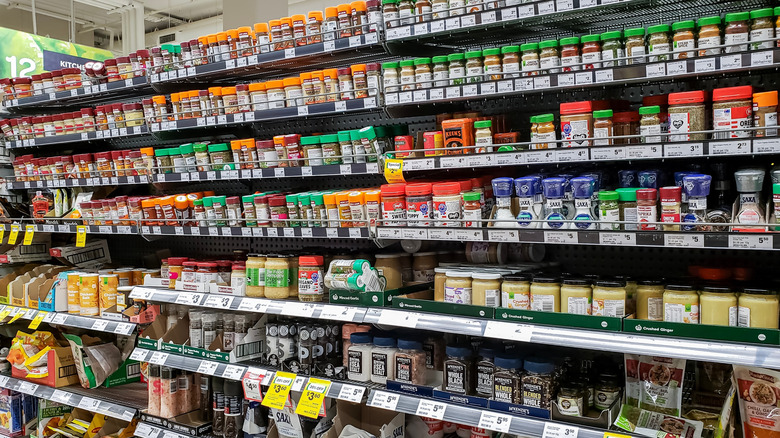 A large and varied seasoning aisle at a grocery store