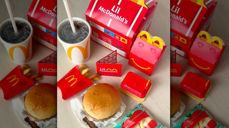 McDonald's Happy Meal with Lil McDonald's toy, burger, fries, apple, and soda
