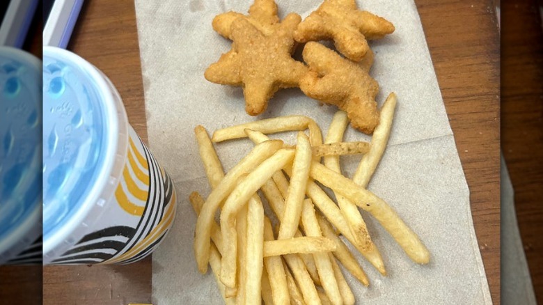 Carl's Jr. kids meal with four chicken stars, fries, and a drink on the side
