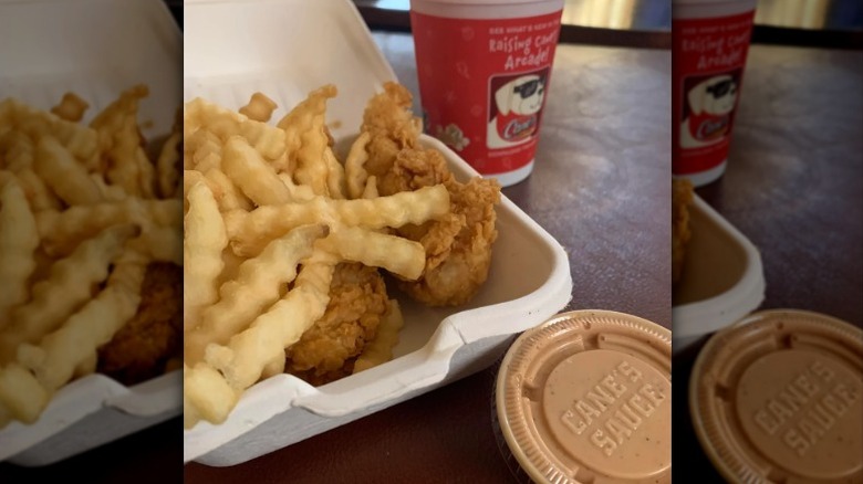Raising Cane's kids meal with two chicken fingers, crinkle-cut fries, Cane's sauce, and a drink