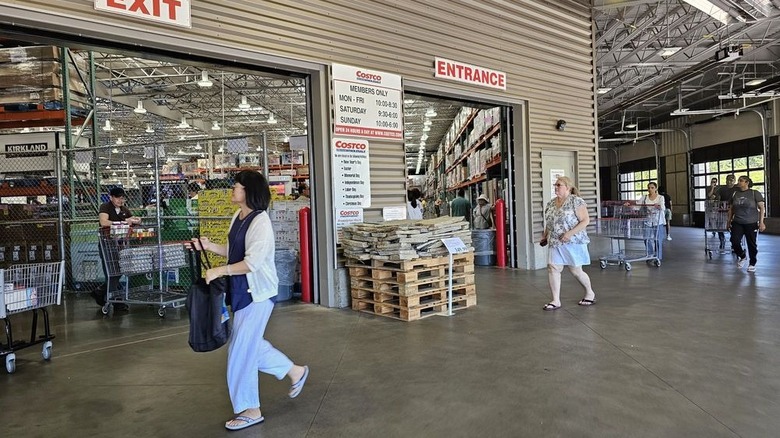 People walking into a Costco entrance