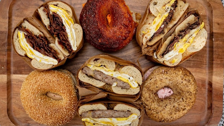 Various assorted bagels with cream cheese and bagel sandwiches with eggs and meats at Olmo