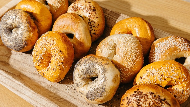 Assorted bagels lined up on a wooden tray at Pork Roll Pete's﻿