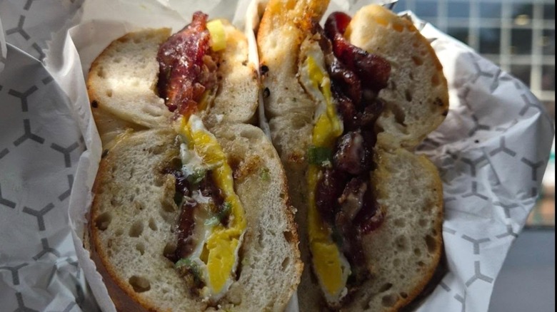 bagel sandwich with cream cheese, bacon, and egg in foil wrapper from Bagel Station 523
