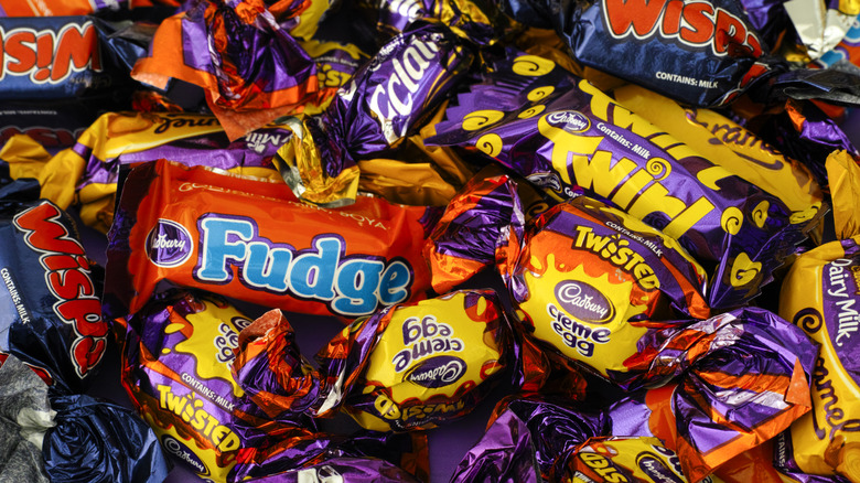 A pile of colorful, wrapped Cadbury chocolates
