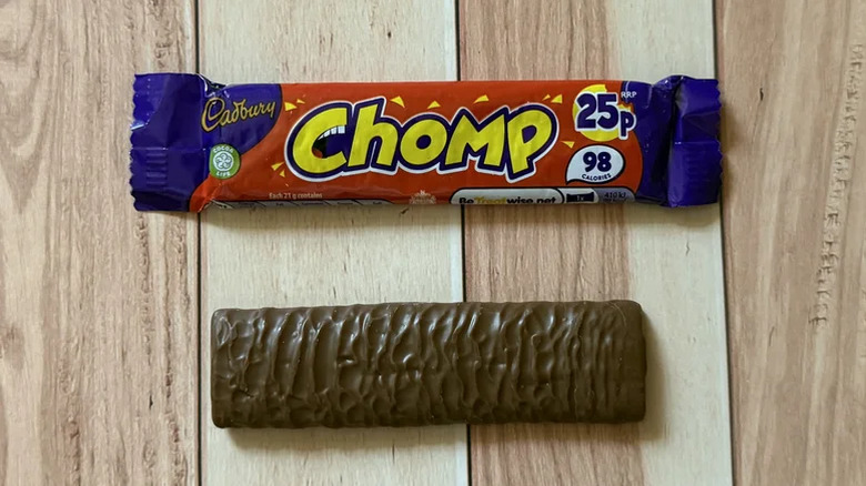 A Chomp bar and its packaging against a wooden background
