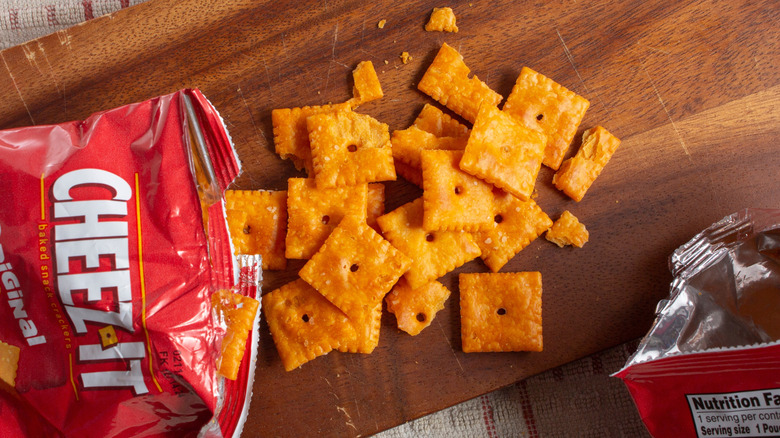 Top view of open bag of Cheez-Its on wooden cutting board