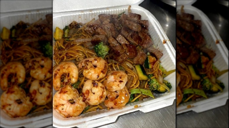 Yakisoba with steak, shrimp, and noodles in a to-go container