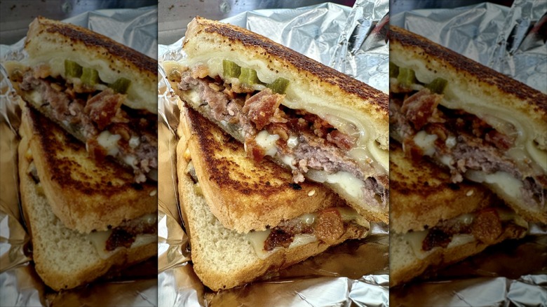Patty melt with bacon and cheese on toast