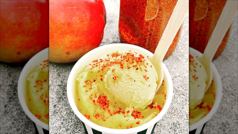 Fresh mango gelato in a paper to-go cup