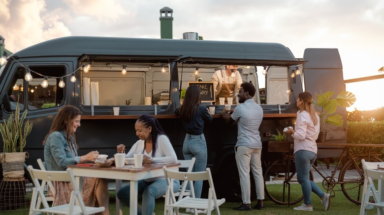 Smiling customers ordering from a mobile food truck