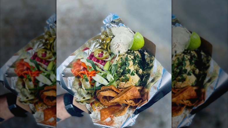 Salt & Lime rice bowl with Yellow curry and basil chicken, white rice, house pickled veg, curry-lime crema, and house fried pita chips