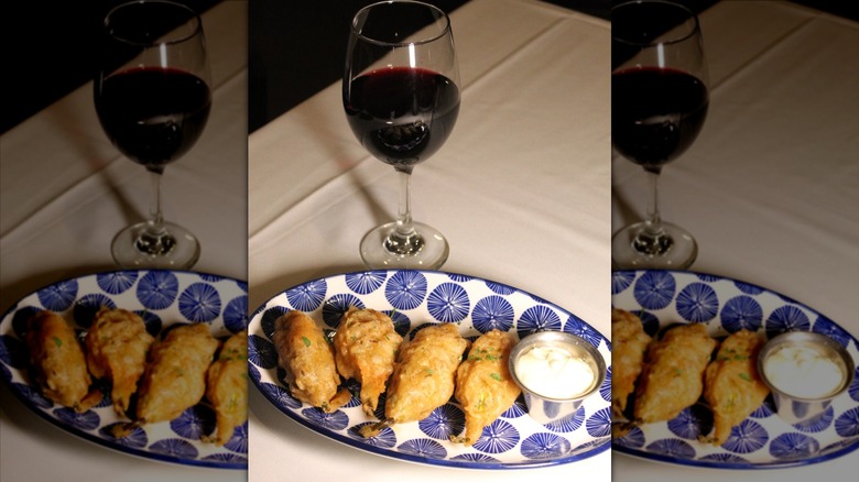 Glass of red wine served with a plated Italian appetizer from The Italian Daughter restaurant in Arizona.