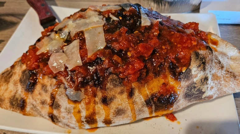 Chicken Parmigiana calzone topped with fresh cheese and marinara from Tutti's Ristorante in Connecticut