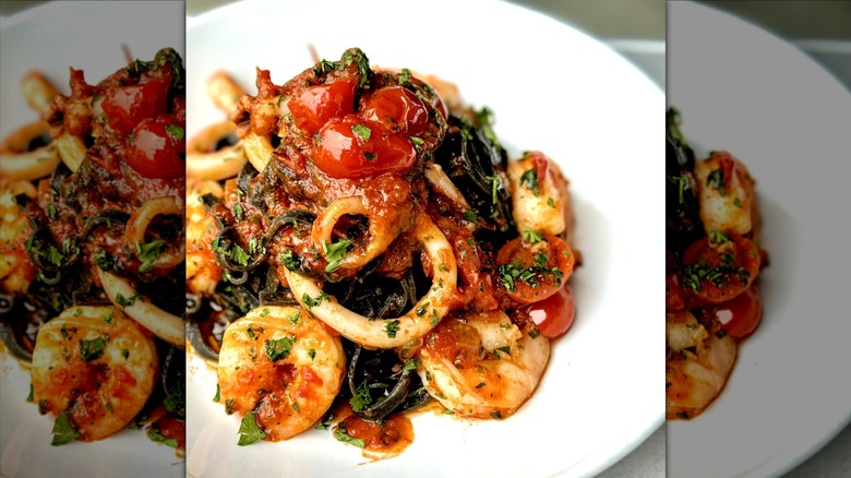 Black Linguine pasta flavored with squid ink and served with squid, shrimp, and tomato sauce from Borti Pasta Bar in Florida