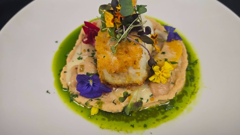 Crisp fish filet dish garnished with fresh flowers from Giovanni's Ristorante