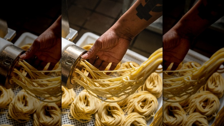 Hands shown making handmade pasta at Esther's Kitchen