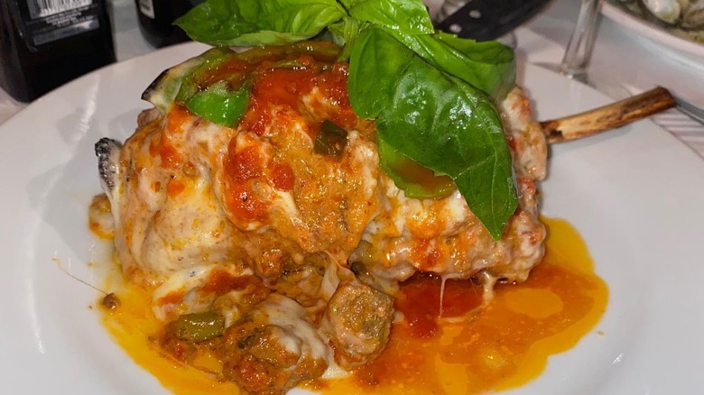 A plate with stuffed veal chop parmigiana bolognese in vodka sauce from Cafe 2825