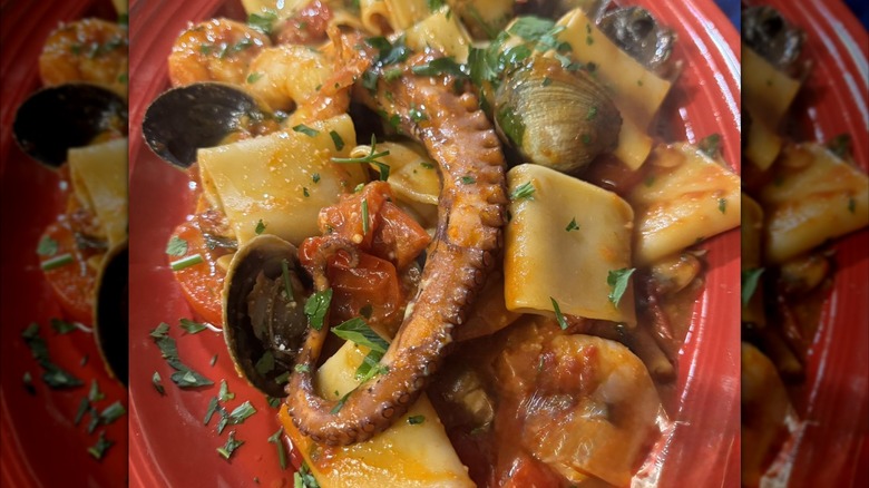 A dish with octopus, little neck clams, and shrimp with pasta in a tomato sauce from Vecchia Osteria