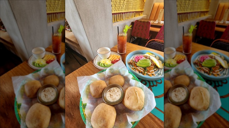The interior of Xolos Tacos + Tlayudas with food and drink on the table