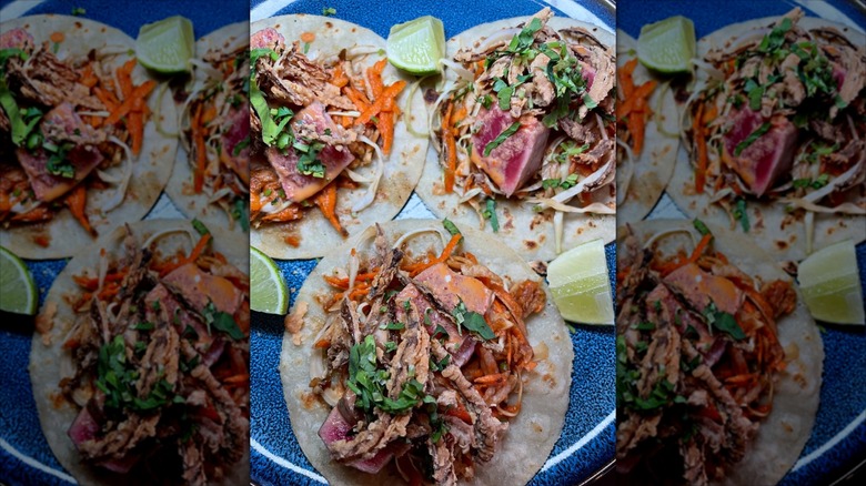 Close-up of a plate of three Asian-inspired tuna tacos at El Mictlan
