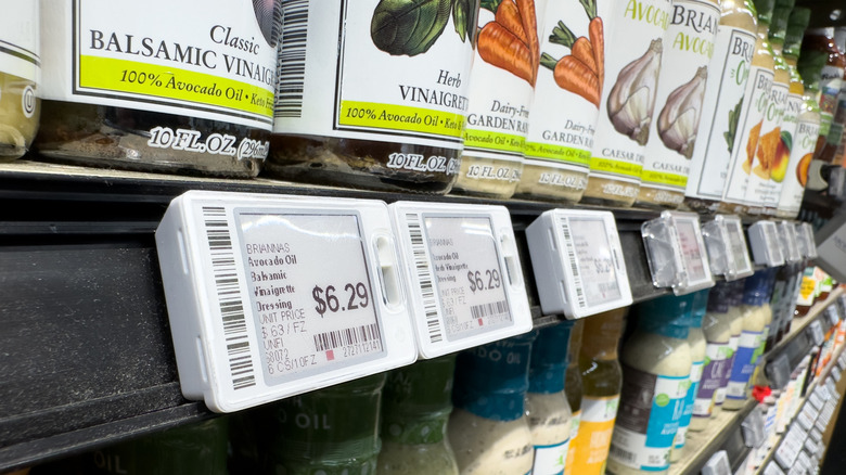 Price tags beneath salad dressings at grocery store