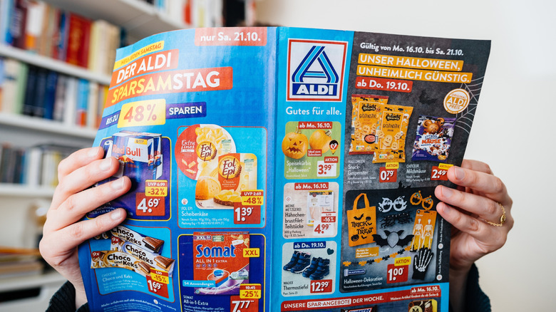 Person reading Aldi ads