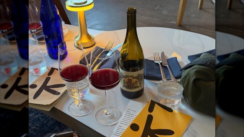 Bottle and two glasses of red wine on a table at Kid Sister wine bar