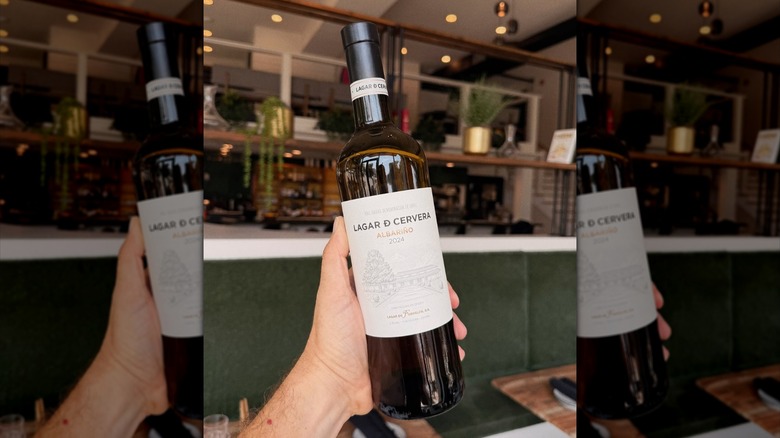 Hand holding a bottle of albariño wine at BCW