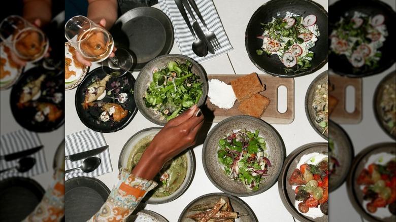 Top view of various plates of Greek food and wine at Krasi