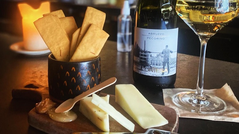 Pecorino cheese, crackers, and a bottle and glass of Pecorino wine from The Hawthorn
