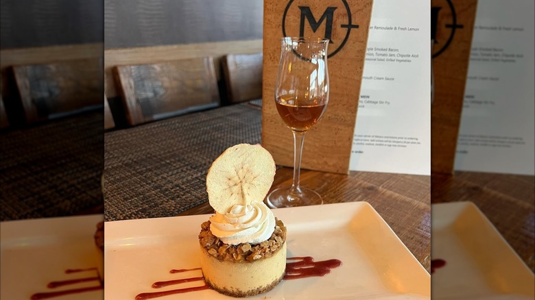 Caramel apple cheesecake and glass of dessert wine from Maxwells