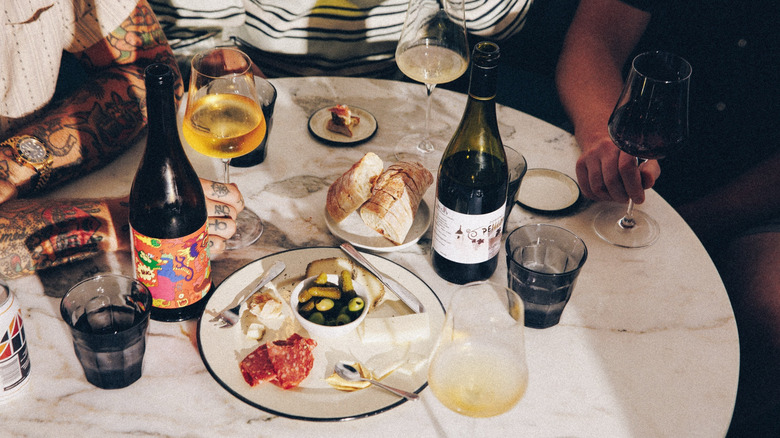 Bottles and glasses of wine, bread, and snacks at Graft